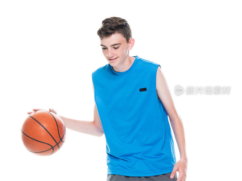 正面视图/一个人/一人/完整的长度/一个十几岁的男孩只有12-13岁英俊的人白人男性/年轻男子篮球运动员/男孩/十几岁的男孩站在白人背景和拿着篮球